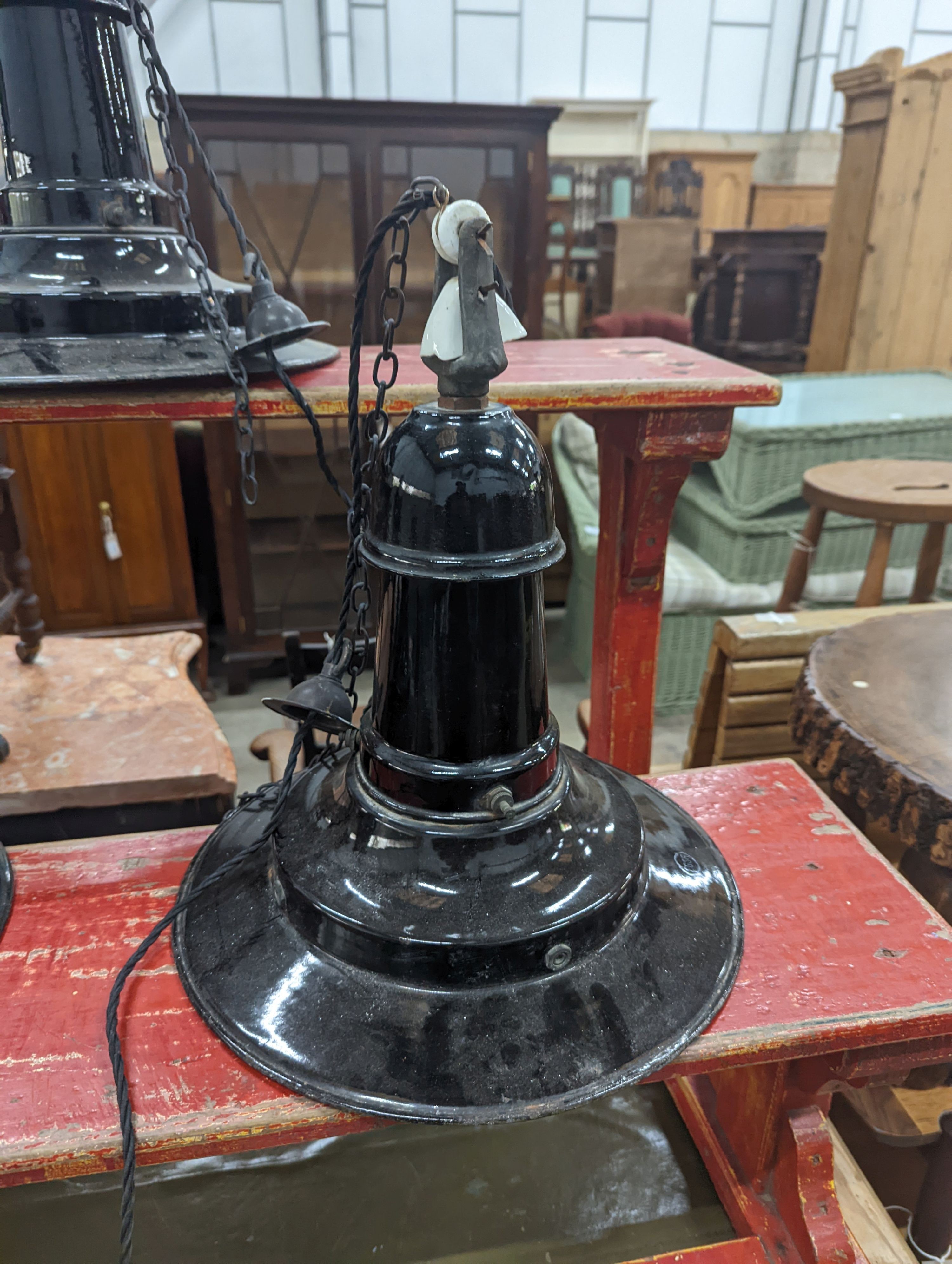 A set of three Continental black enamelled industrial style ceiling shades, height including fittings 39cm